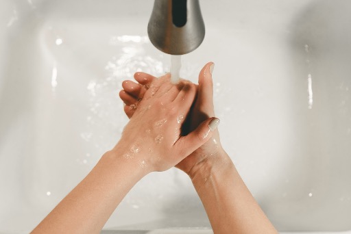 persons feet on white bathtub